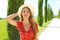 Holidays in Italy. Close up of beautiful girl in Tuscany. Young traveler woman walking in cypresses lane on sunny day. Copy space