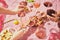 Holidays meeting. Female hands with glassed with red and rose wine on pink textured background, tablecloth with