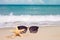 Holidays. sand beach, sunglasses and starfish