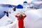 Holidays in Santorini. Back view of traveler woman descends stairs in the traditional village of Oia with blue domes churces and