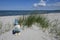 Holidays by the sea ... Dunes, white sandy beach and a little dwarf in front of the blue ocean.