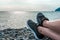 Holidays at sea, vacation and travel concept-young girl resting lying on the sea, legs in sneakers close-up, summer adventures,