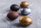 Holidays, traditions and Easter concept - Dark stylish easter eggs on grey background.