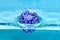 Holidays and vacation concept. Festive decoration for Christmas tree, blue ball dropped into water with splashes, blue