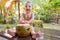 Holidays vacation concept. Little child infant shouts while sitting on the table. It holds coconut which is made as a symbol of