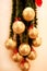 Holidays wreath of fir branches with Christmas baubles. Twigs pine, golden balls and red bows as Christmas decorations on wall.