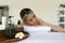 Holistic luxury wellness experience. A serene woman reclining leisurely within a soothing spa ambiance, surrounded by elements