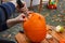 Hollowing out a pumpkin to prepare halloween lantern