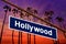 Hollywood California road sign on redlight with pam trees photo