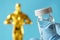 Hollywood Golden Oscar Academy award statue and hand in gloves with vaccine aganist coronavirus on blue background. Success and vi