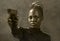 Hollywood movie style portrait of young attractive and confident black African American woman holding gun as special federal agent