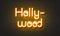 Hollywood neon sign on brick wall background.