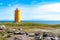 Holmsberg Lighthouse, an orange light house on the Reykjanes Peninsula in Iceland