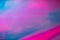 Holographic effect blurred pink and blue background.