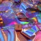 Holographic rainbow iridescent fabrics surface and objects from the 90s shuttlecock, racket, audiocassette, 80s retrospective,