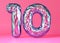 Holographic, shiny number ten on pink, vibrant background. Symbol 10. Tenth birthday party, business anniversary