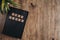 Holy Bible in block letters on a bible whit a plant on a wooden table