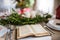 Holy bible book on a table set for a dinner at home at Christmas time.