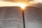 Holy Bible open at sunset with highlight on Malachi 4:2. Background with clouds and sun