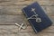 Holy bible with silver cross on wooden background