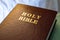 Holy Bible text on a leather cover book brown color, close up view