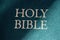 Holy Bible title closeup in sunlight. Religion and faith concept. Religious literature. Bible .