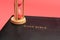 Holy Bible, the Word of God with hourglass. Isolated on red background. Top view. Close-up. Copy space. Horizontal shot