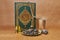 holy book of Muslims and oud perfume, dates fruit and glass bottle, iftar ramadan concept
