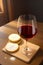 Holy communion wafers and wine in a glass on a wooden table generated by ai