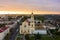 Holy Cross Church And Traffic In Mostowaja And Kirova Streets At Evening in the morning light. Grodno city in Belarus. Aerial view