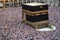 Holy Kaaba. Crowd of muslims walking around Kaaba for Tawaf during Hajj