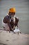Holy man brahman washing by Ganges river in India