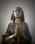 Holy Mary statue bronze that prays with folded hands