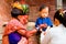 Holy Sadhu man with traditional painted face and colouful clothes is blessing a child at Pashupatinath Hindu Temple complex near K