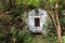 The holy spring of living water, the old 17th century font, moss-covered walls, autumn. Well of holy water with spring water, well