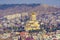 Holy Trinity Cathedral in Tbilisi. Panorama from the mountain on the background of the city and surrounding buildings.