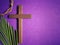 Holy Week, Lent, Palm Sunday, Good Friday, Easter Sunday Concept. Cross, palm leaf and crown of thorns in purple background.