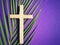 Holy Week, Lent, Palm Sunday, Good Friday, Easter Sunday Concept. Wooden cross with palm leaf in purple background.