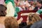 Holy Week in Malaga, Spain. Girl receiving candle wax.