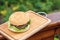 Homamade beef or pork hamburger with vegetable on chopping board in garden, food photoraphy