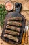 Homamade grilled Lula kebab meat sausages on a cutting board. wooden background. Top view