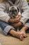 Homan people and dog love concept - adult caucasian woman hug with tenderness her old pug puppy sitting on the floor at home -