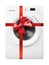 Home appliance - Front view Washing machine gift tied red bow. Isolated