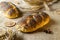 Home baked bread. Rye bakery with crusty loaves and crumbs. Fresh rustic traditional bread with poppy seeds, wheat grain ear on