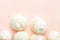 Home baked meringue cookies scattered on light pink background. French Italian Swiss cuisine desserts