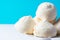 Home baked meringue cookies on white cake stand on blue white background. French Italian Swiss desserts