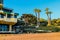 A home on the beach near a lush green hillside with palm trees at El Matador beach