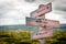 home of the brave text on wooden american flag signpost outdoors