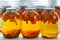 Home canning: large glass cylinders with apricot compote.