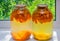 Home canning: large glass cylinders with apricot compote.